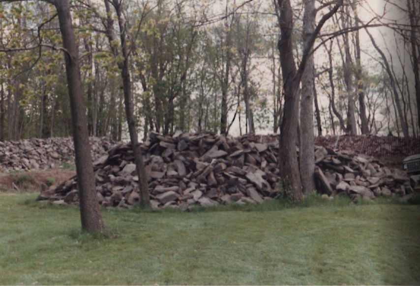 Fieldstone stockpiled before going into the slip-form walls
